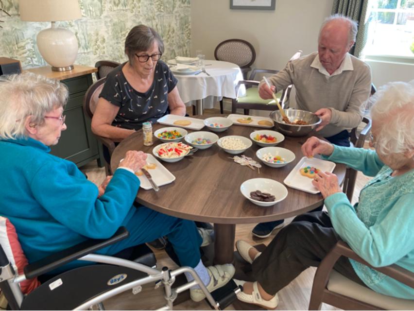Residents decorate cookies for Easter