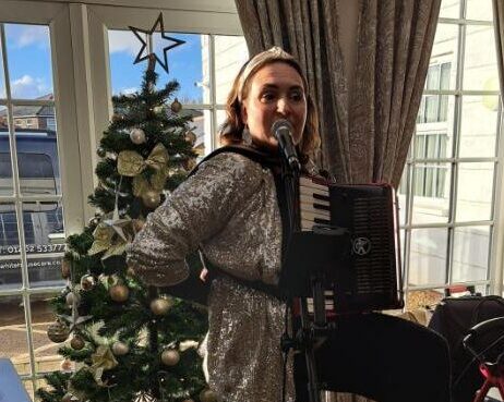 woman playing musical instrument for christmas party in lounge